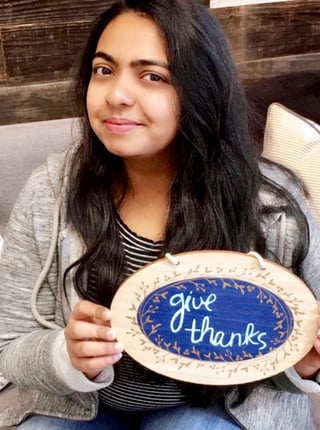 Shruti holding a give thanks 