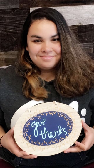 Marisa holding a give thanks