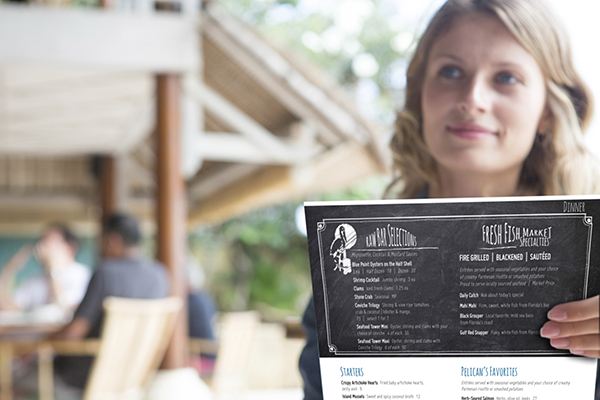 woman holding a menu
