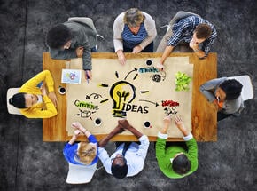 people collaborating an idea over a table