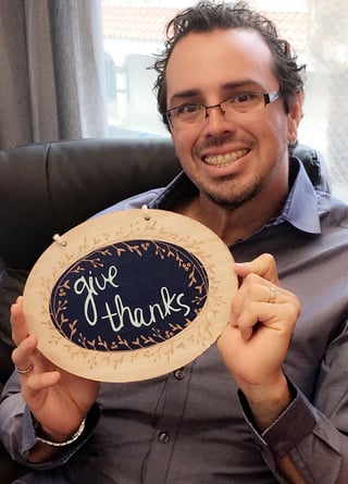 Jorge with a placard give thanks