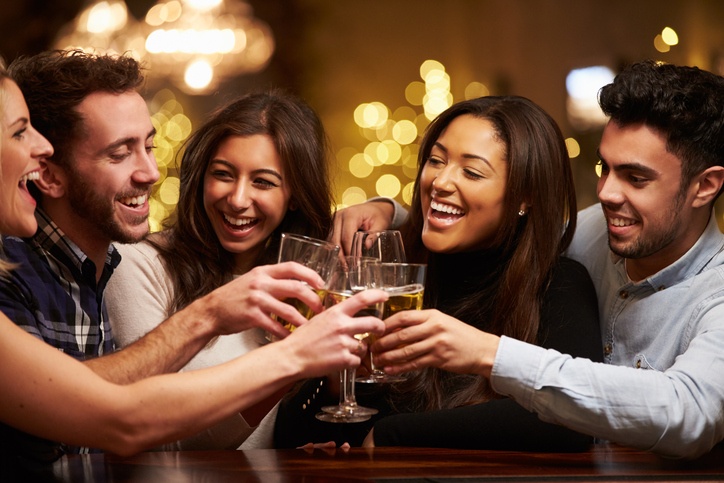 A crowd of friends having a toast of beer