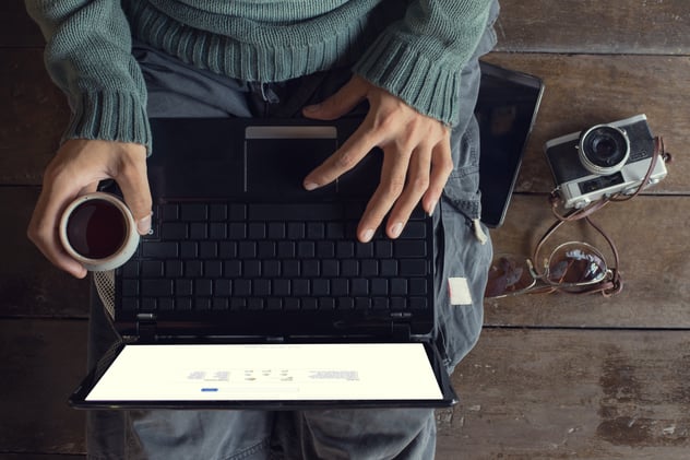 man sitting with coffee and laptop