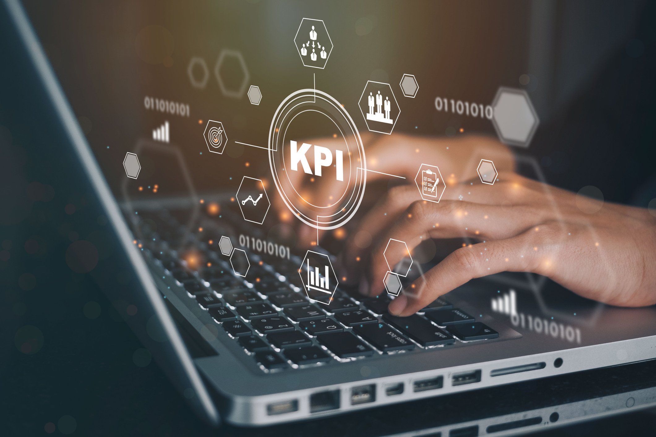 hands on laptop keyword with an overlay illustration showing the letters "KPI" in a circle and from it there are other analytics metrics. 