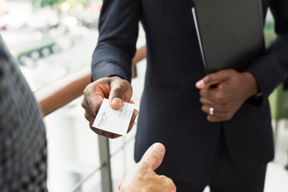 A man with his card number giving away to a woman