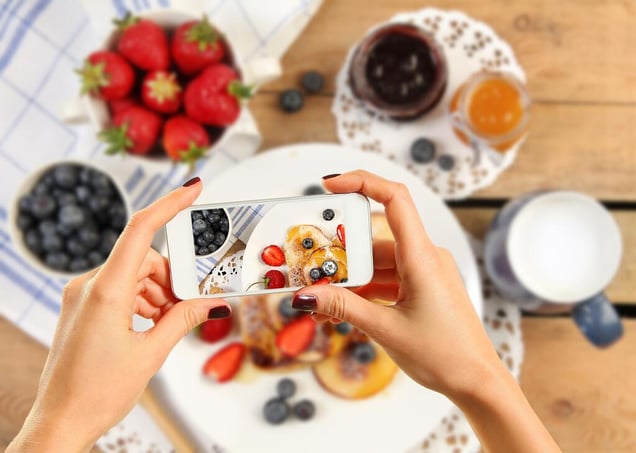 A woman's hand taking a picture from her phone