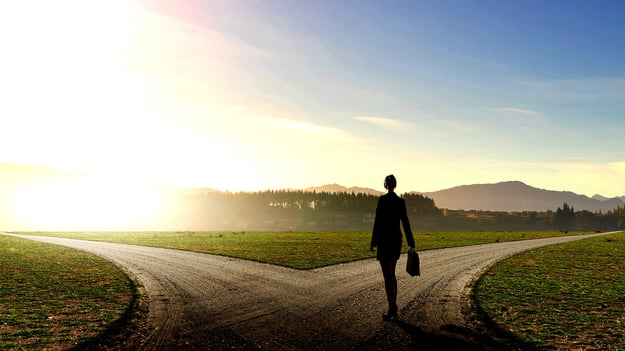 A woman standing at the middle of the road