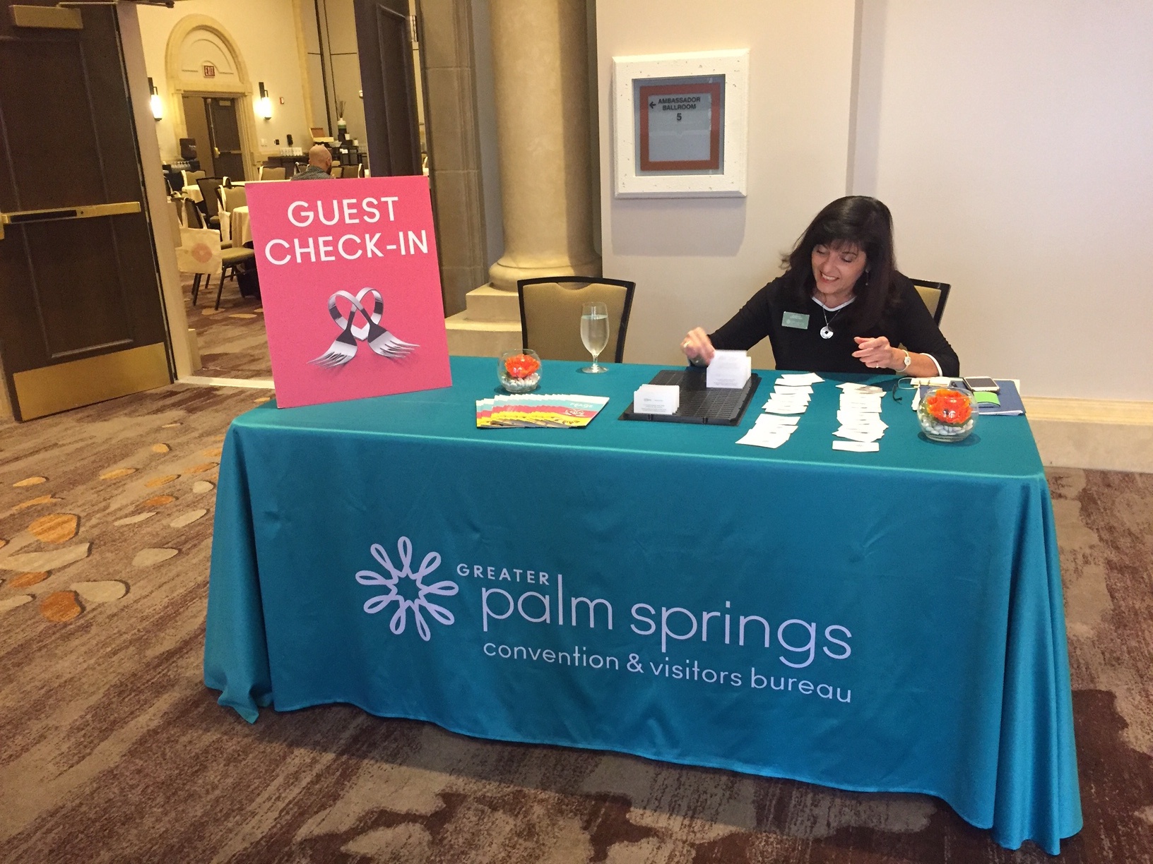 Guest check in booth with a woman 