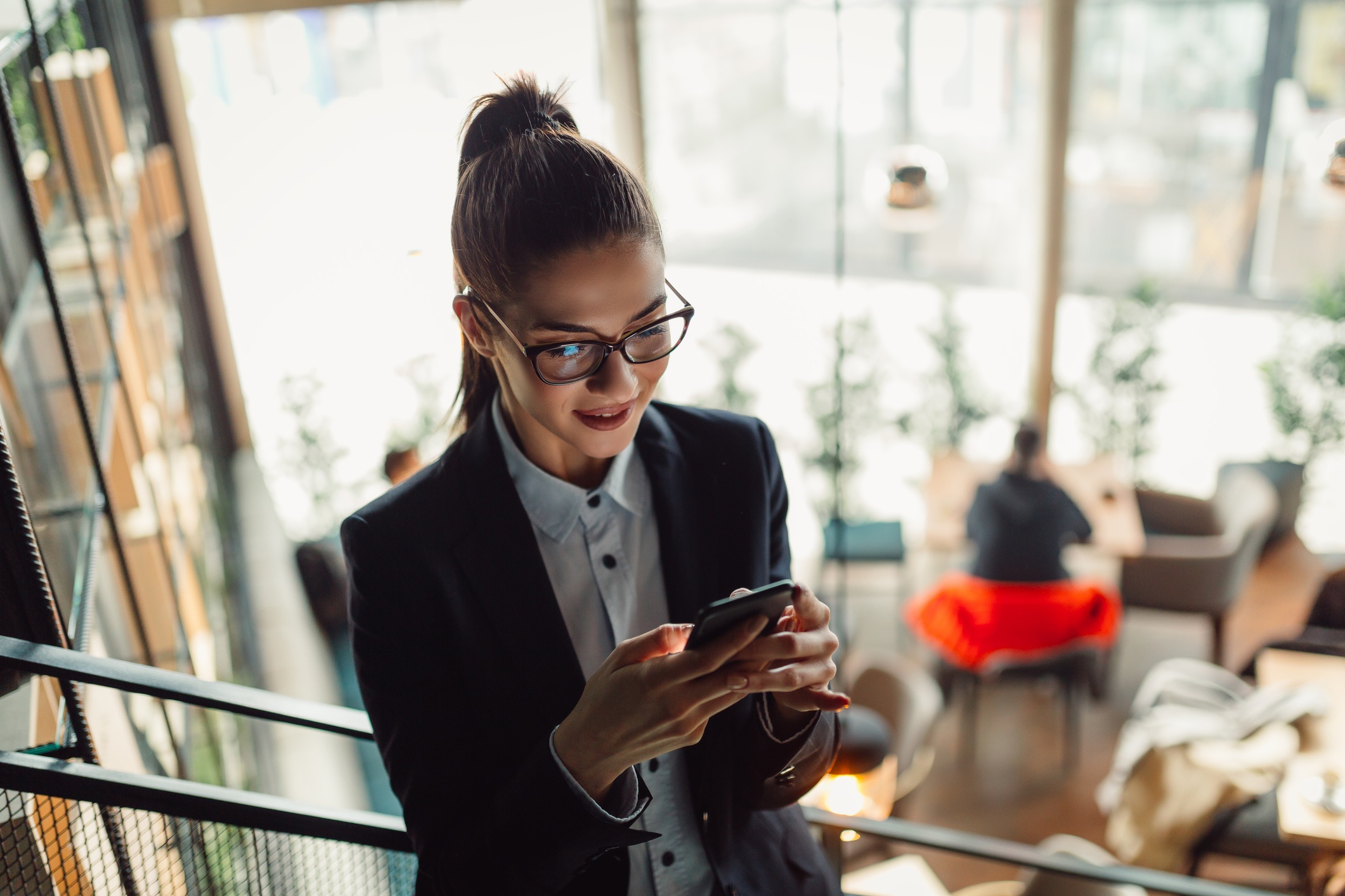 A woman smiling at her phone