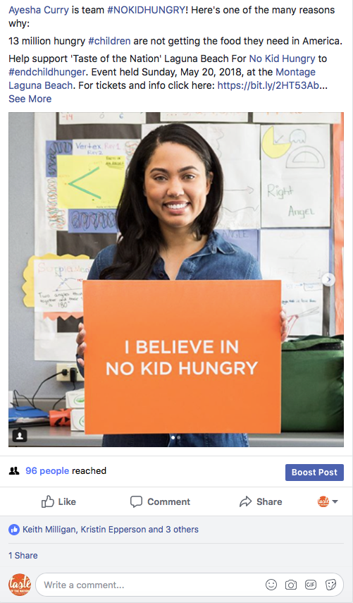 A woman holding a sign says No kid hungry