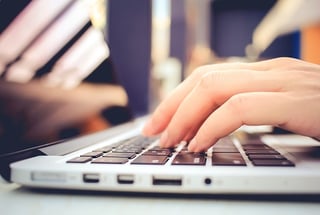 hand typing on a keyboard