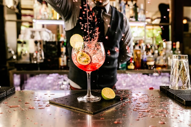 a man pouring wine on the glass