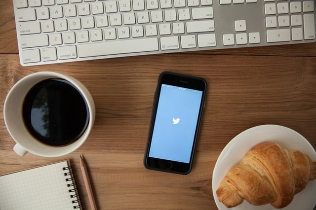 a bread coffee notebook and a phone