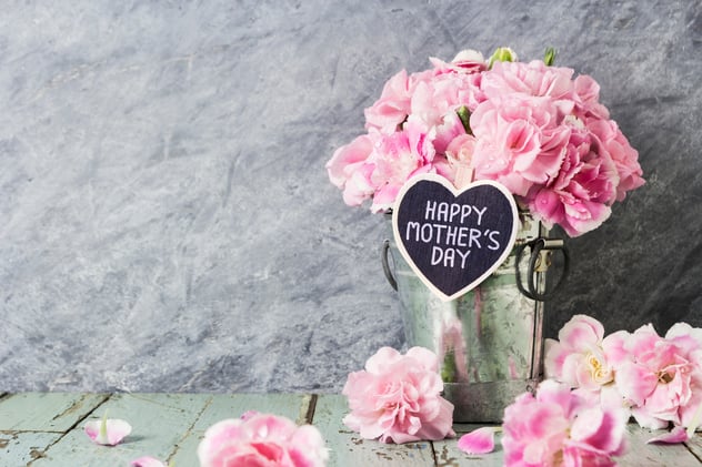 flower on a table with happy mothers day note