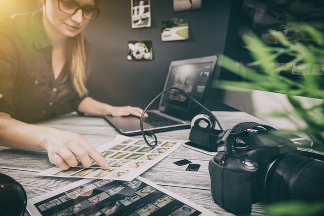 a woman analyzing pictures on the table