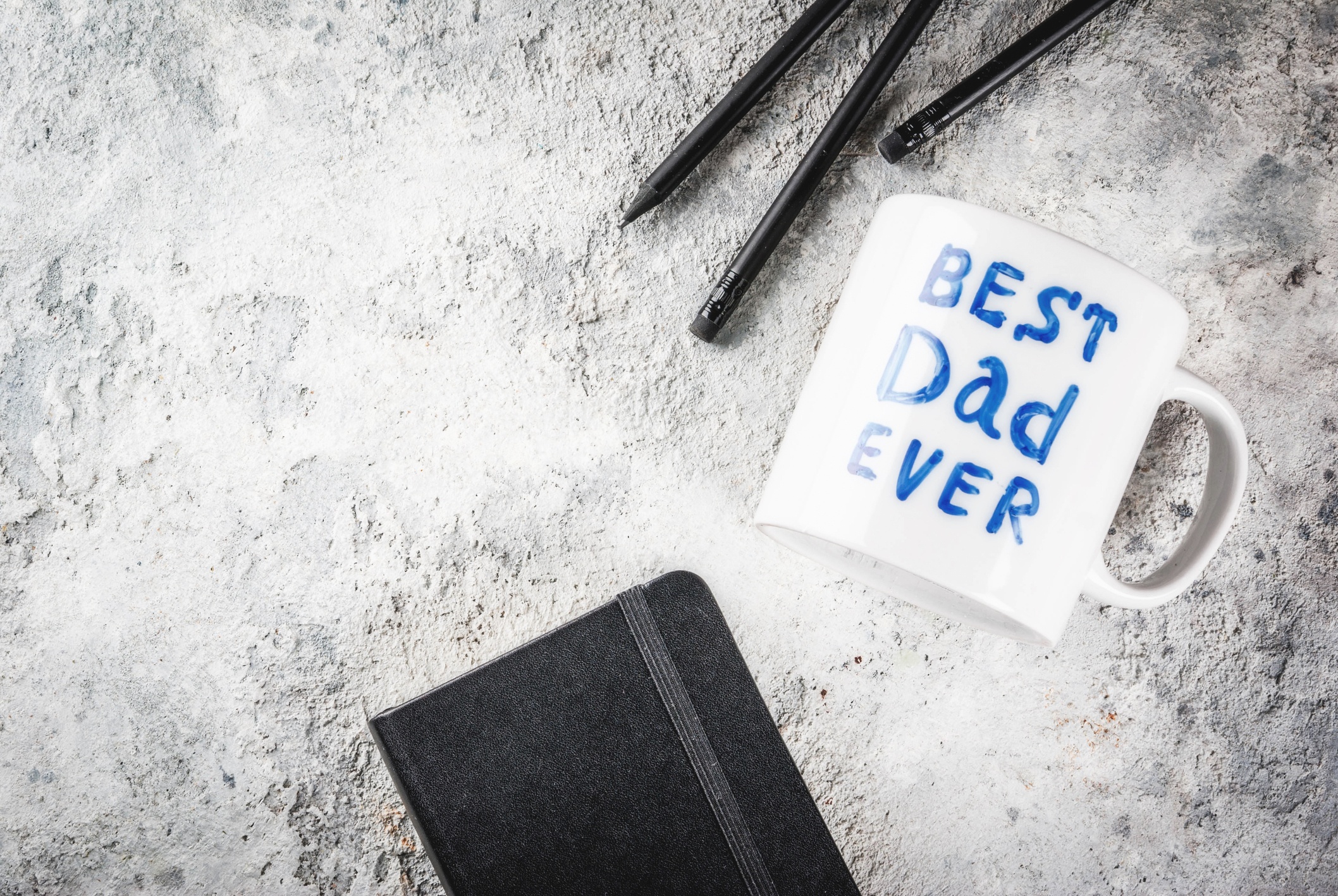 A planner a pen and a mug on the table