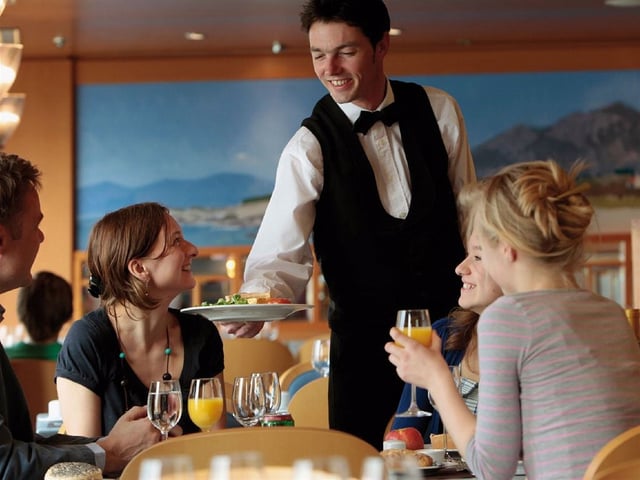 waiter serving foods to the customers