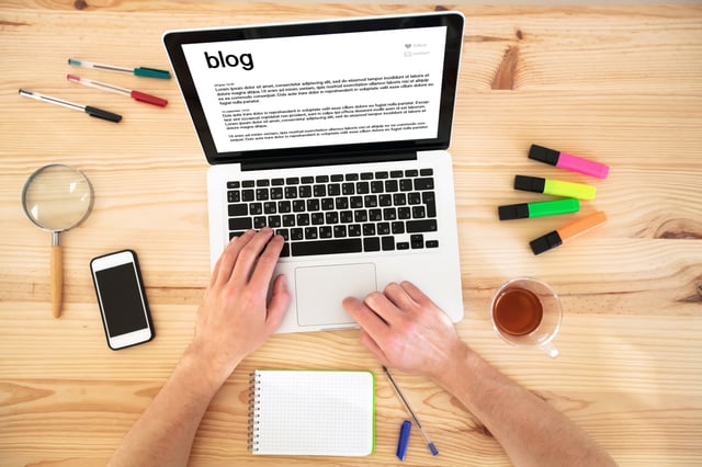 man working on his blog on a laptop