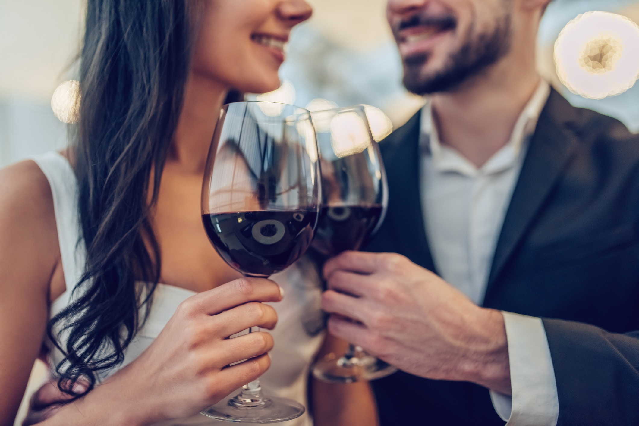 A couple having a toast over a glass of wine