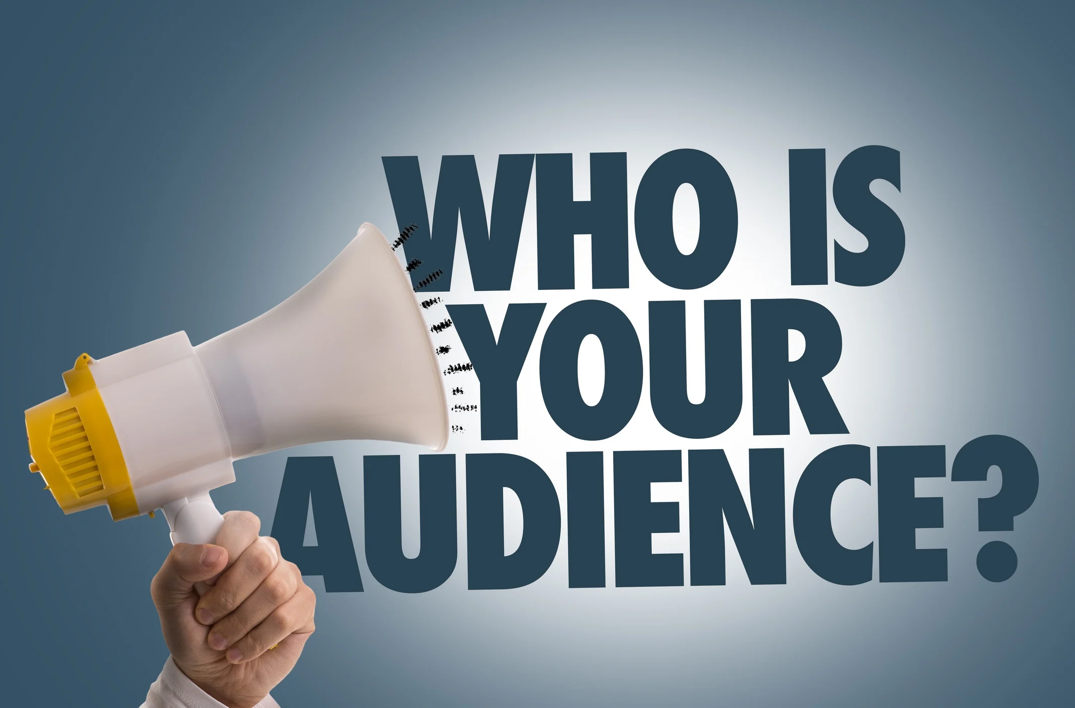 A hand with a microphone saying Who is your audience