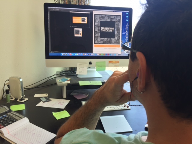 a man working on rebranding checklist on his computer